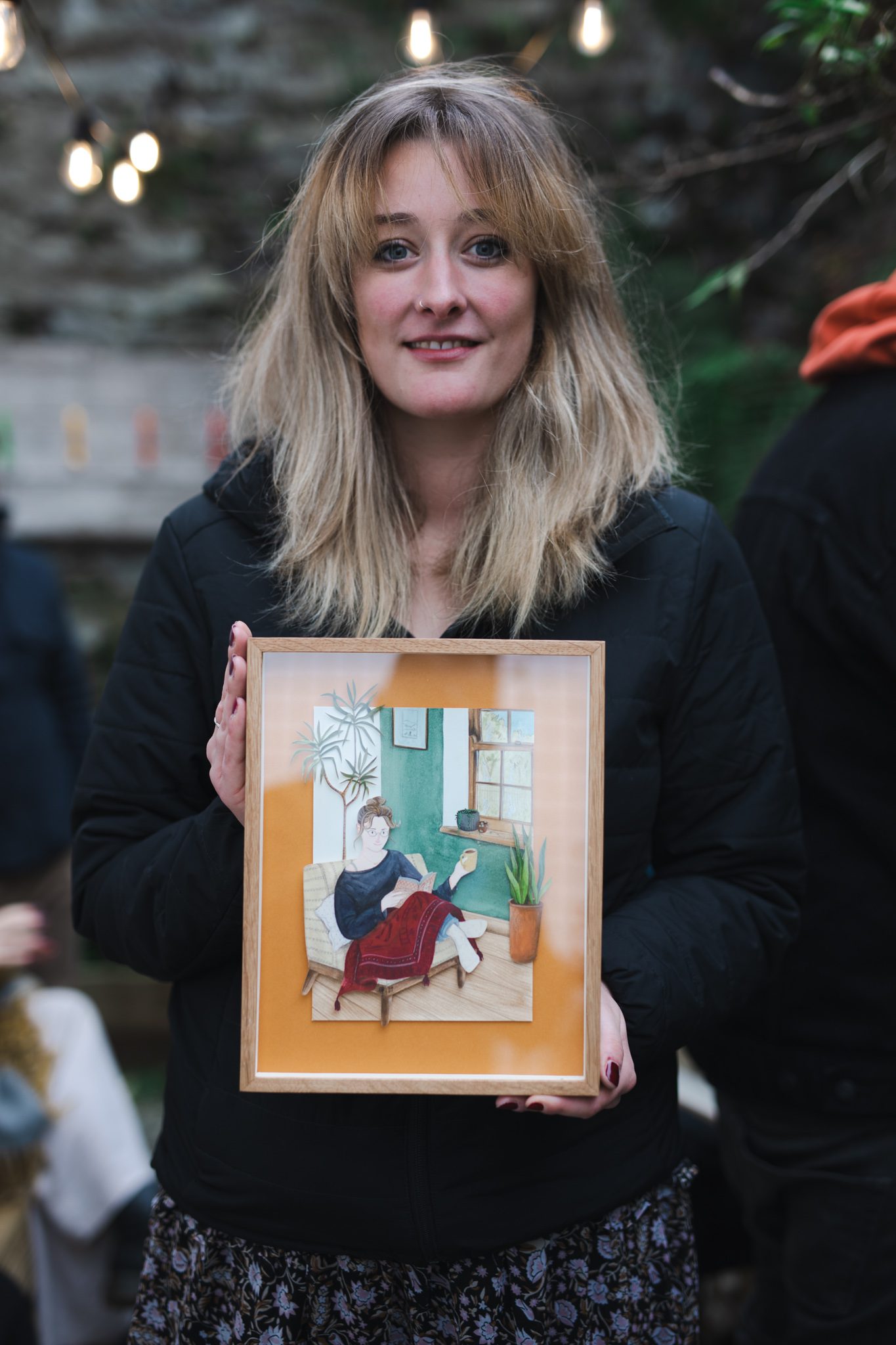 Tilly holding portrait by artist Bex Bourne