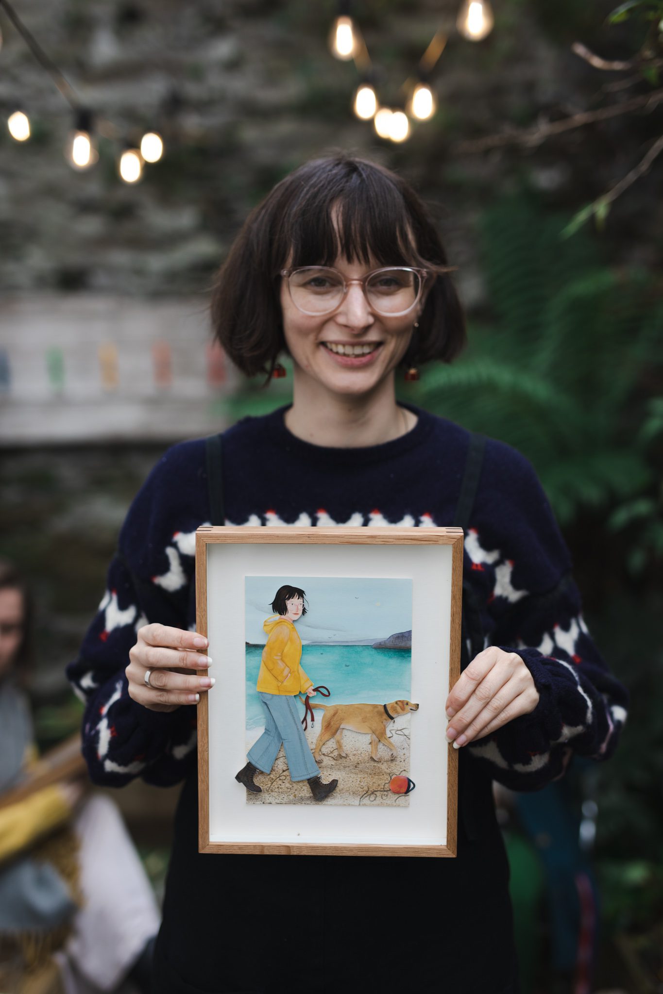 Sophie holding portrait by artist Bex Bourne