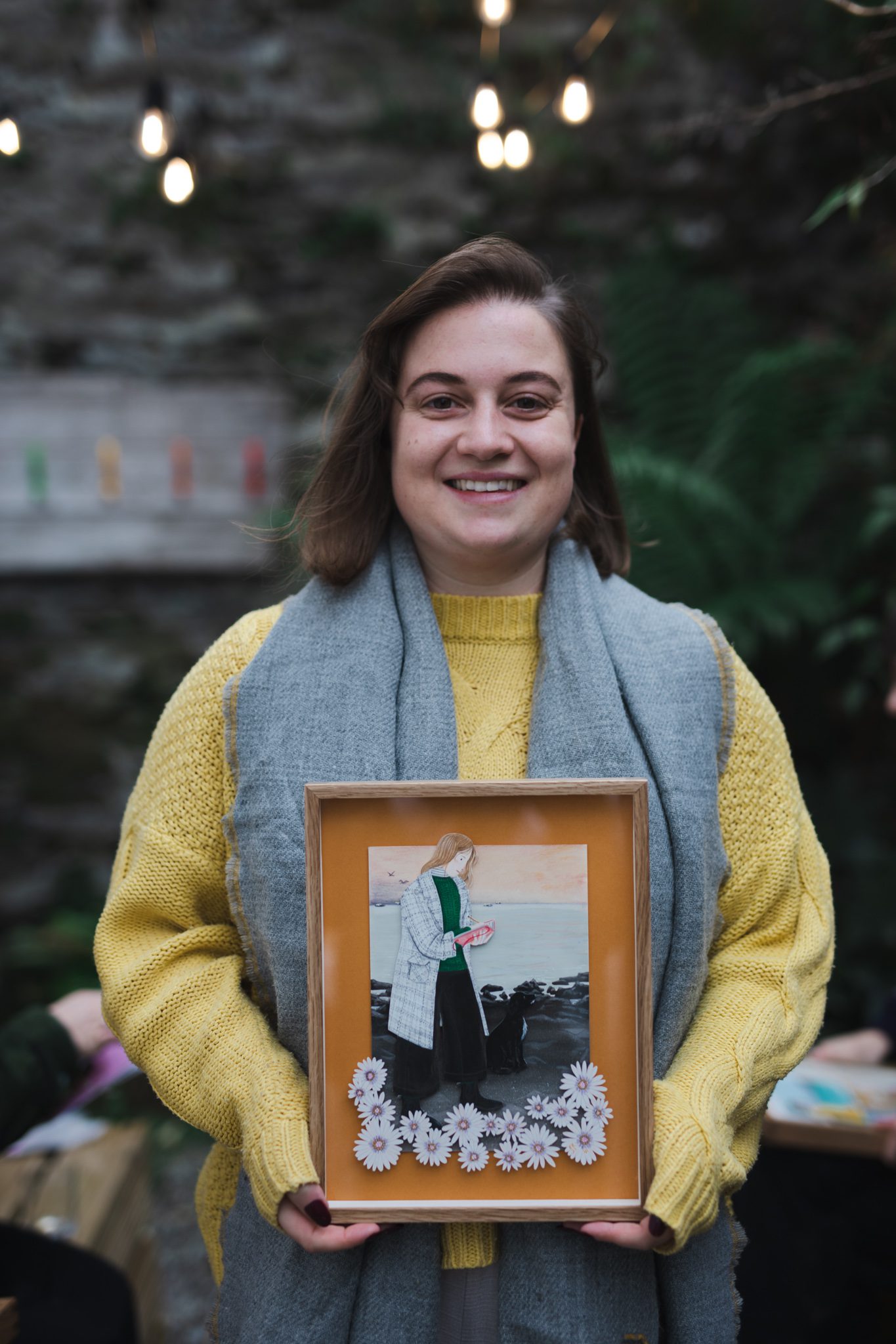 Emily holding portrait by artist Bex Bourne