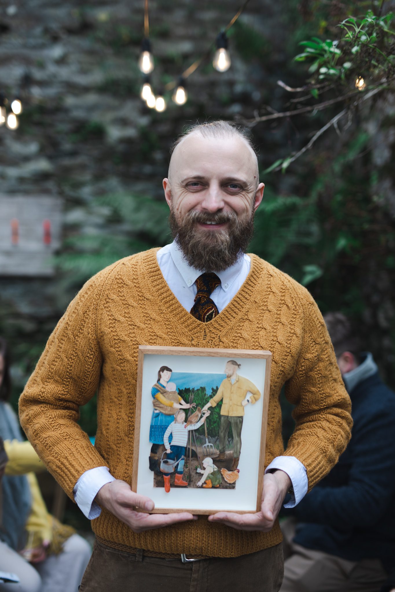 Daniel Gradwell holding portrait by artist Bex Bourne