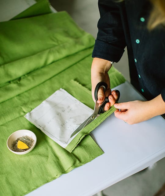Cutting green linen clothing designer